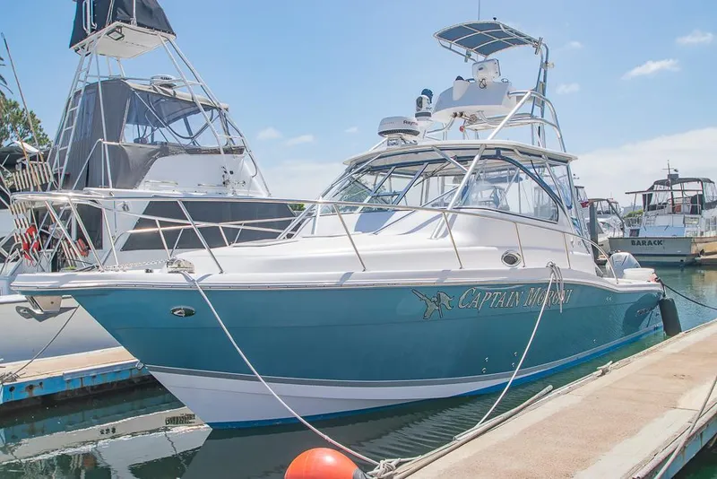The Image of 2009 Pro-Line 35 Express boat docked at marina under clear blue sky. - 1