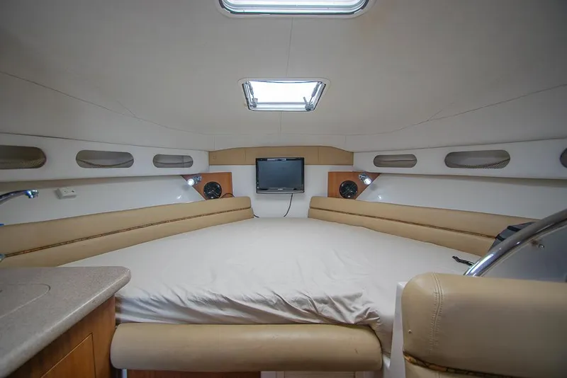 Slide: The Image of 2009 Pro-Line 35 Express cabin interior with bed, TV, and modern amenities. - 13