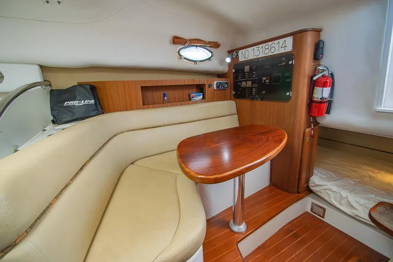 Slide: The Image of 2009 Pro-Line 35 Express cabin interior with seating, table, and control panel. - 15