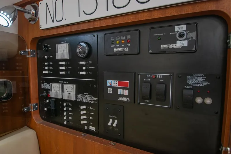 Slide: The Image of Control panel of a 2009 Pro-Line 35 Express boat, featuring various switches and gauges. - 16