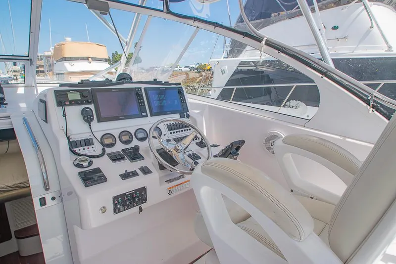 Slide: The Image of 2009 Pro-Line 35 Express boat cockpit with modern navigation equipment and dual seating. - 22