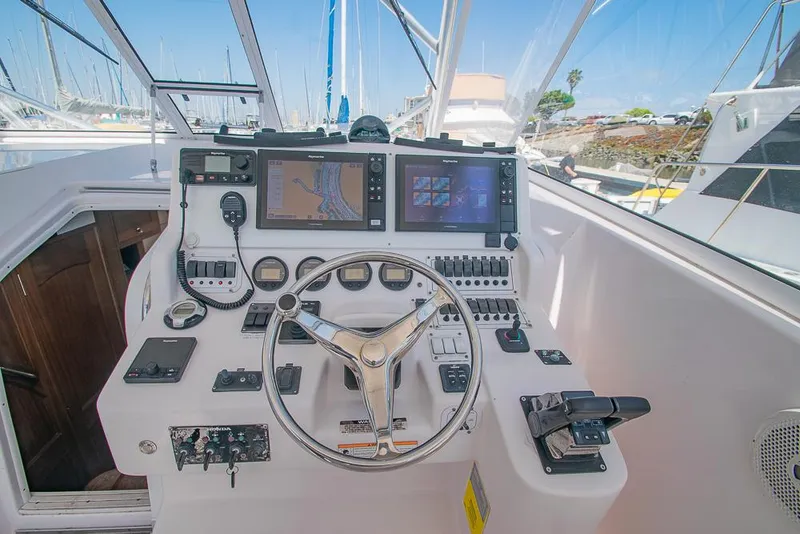 Slide: The Image of 2009 Pro-Line 35 Express boat helm with modern navigation equipment and steering wheel. - 23
