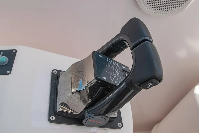 Slide: The Image of Throttle control of a 2009 Pro-Line 35 Express boat, featuring a sleek black handle. - 26