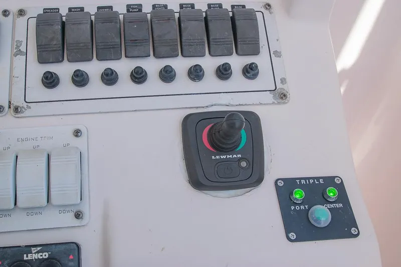 Slide: The Image of Control panel of a 2009 Pro-Line 35 Express boat with switches and joystick. - 28