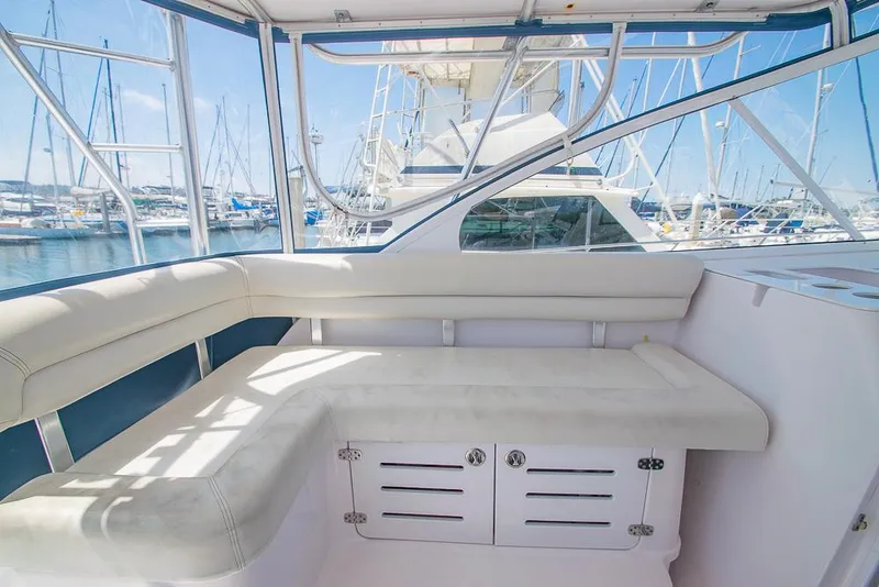 Slide: The Image of 2009 Pro-Line 35 Express boat interior with white seating and marina view. - 30