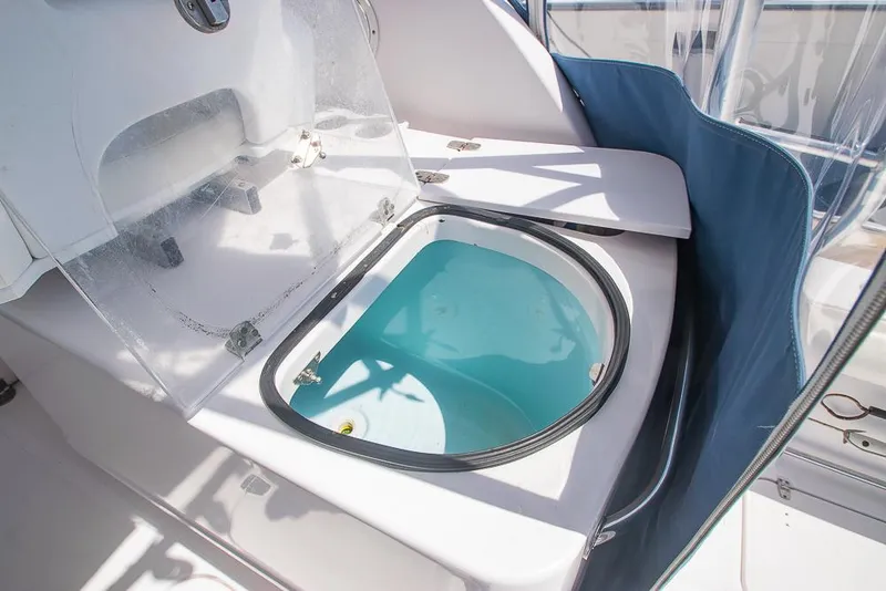 Slide: The Image of Livewell on 2009 Pro-Line 35 Express boat, open lid, blue interior, clear cover. - 31