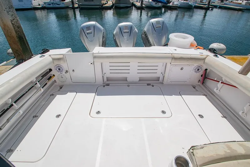 Slide: The Image of 2009 Pro-Line 35 Express boat deck with triple outboard motors at marina. - 32