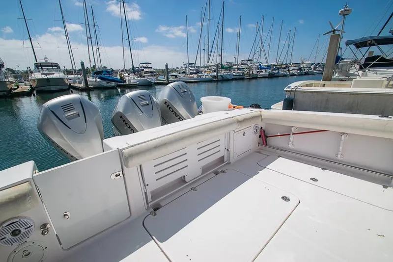 Slide: The Image of 2009 Pro-Line 35 Express boat with triple outboard motors docked at a marina. - 33