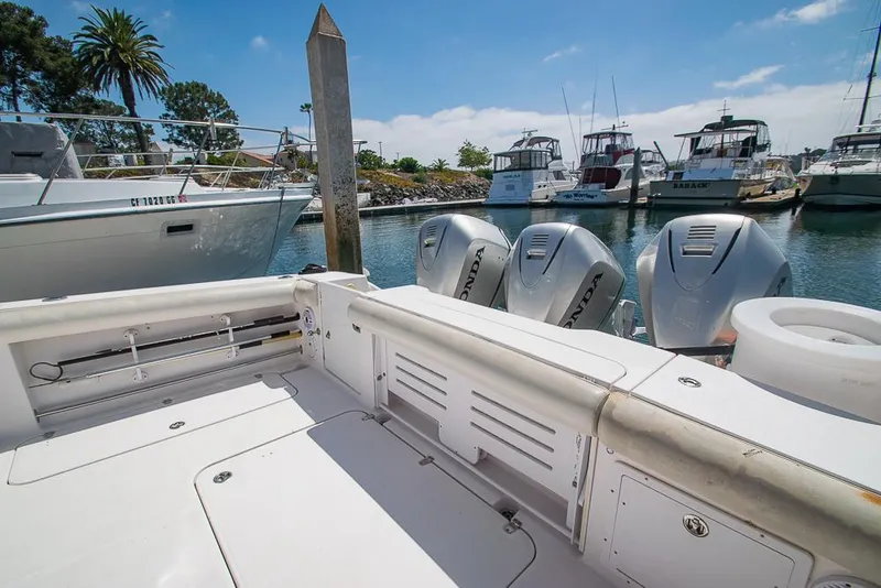 Slide: The Image of 2009 Pro-Line 35 Express boat with triple outboard motors docked at a marina. - 34
