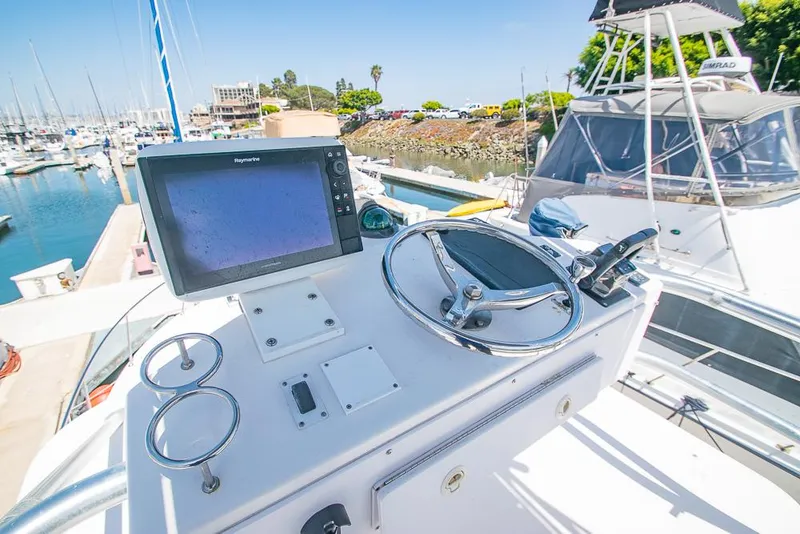 Slide: The Image of 2009 Pro-Line 35 Express boat helm with steering wheel and navigation system at marina. - 37