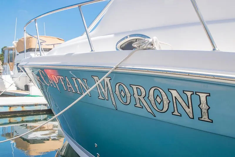 Slide: The Image of 2009 Pro-Line 35 Express boat named "Captain Moroni" docked at a marina. - 4