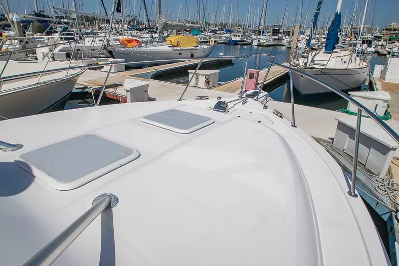 Slide: The Image of 2009 Pro-Line 35 Express boat docked in a marina with multiple sailboats. - 42