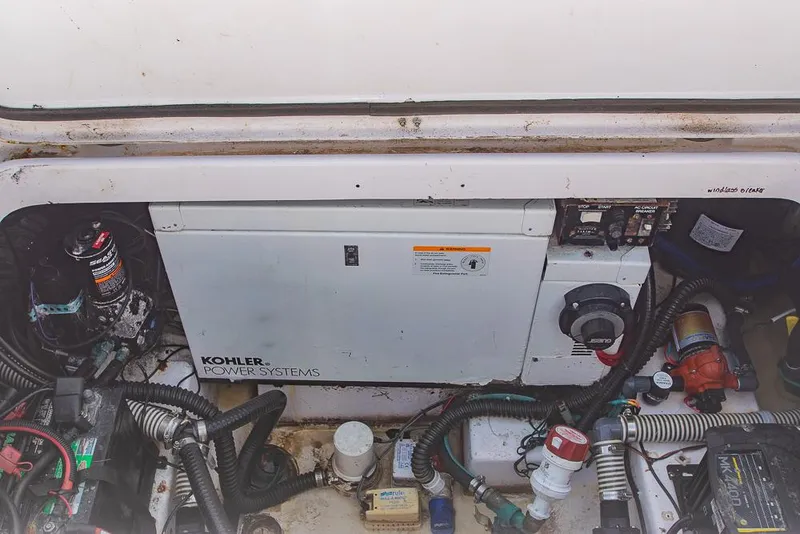 Slide: The Image of Engine compartment of 2009 Pro-Line 35 Express with Kohler power system and various components. - 47