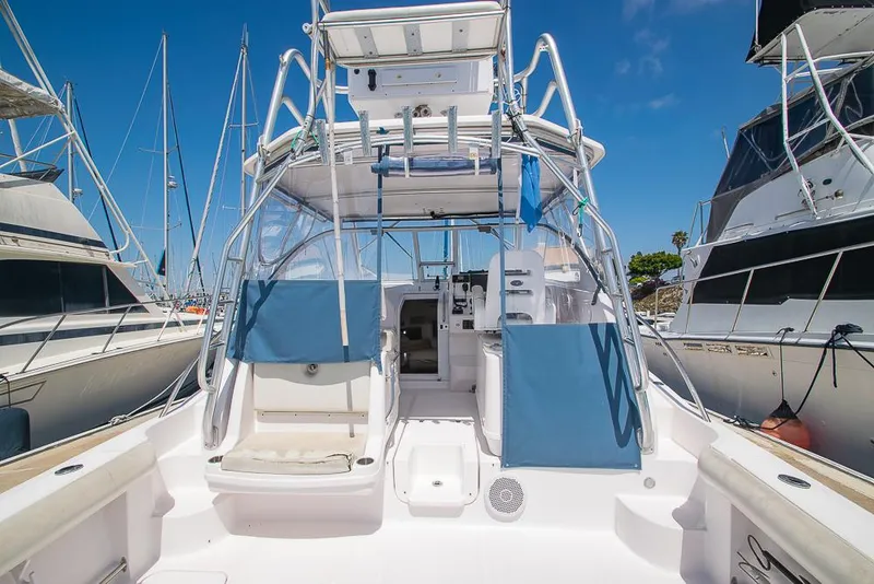 Slide: The Image of 2009 Pro-Line 35 Express boat with blue seating, docked at a marina. - 7