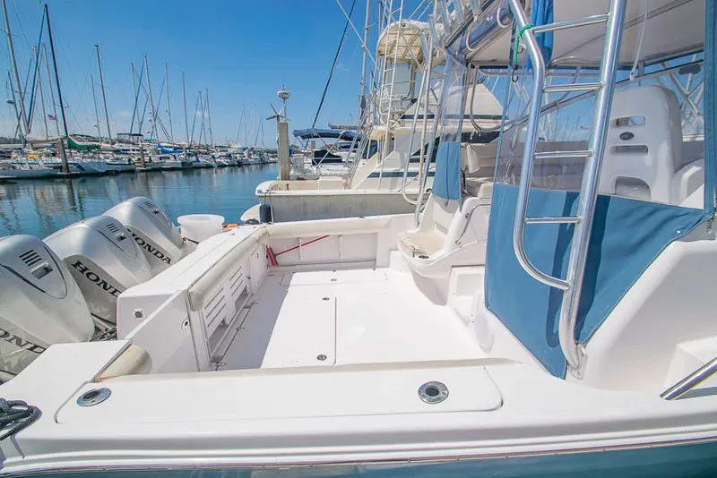 Slide: The Image of 2009 Pro-Line 35 Express boat docked, featuring spacious deck and Honda outboard engines. - 8