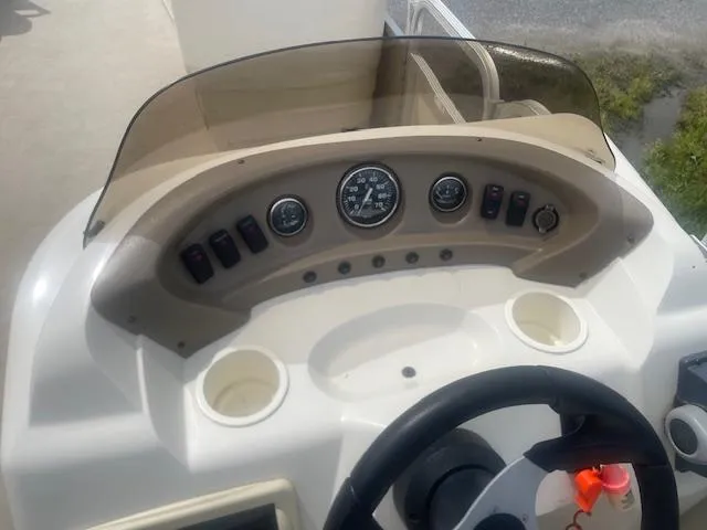 Slide: The Image of 2008 Sedona LC 25 boat dashboard with gauges and controls. - 3