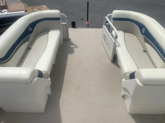 Slide: The Image of 2008 Sedona LC 25 boat interior with white and blue seating. - 4