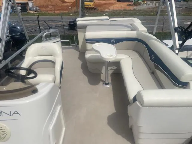 Slide: The Image of 2008 Sedona LC 25 boat interior with white seating and steering console. - 5