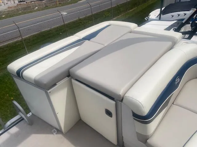 Slide: The Image of 2008 Sedona LC 25 boat seating area with cushioned benches and storage compartments. - 6
