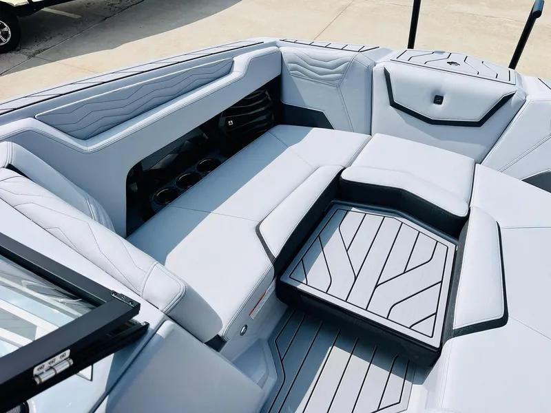 Slide: The Image of 2025 Nautique Super Air G23 boat interior with sleek, modern seating and stylish design. - 12