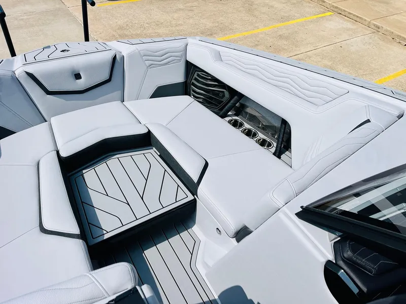 Slide: The Image of 2025 Nautique Super Air G23 boat interior with sleek seating and cup holders. - 13