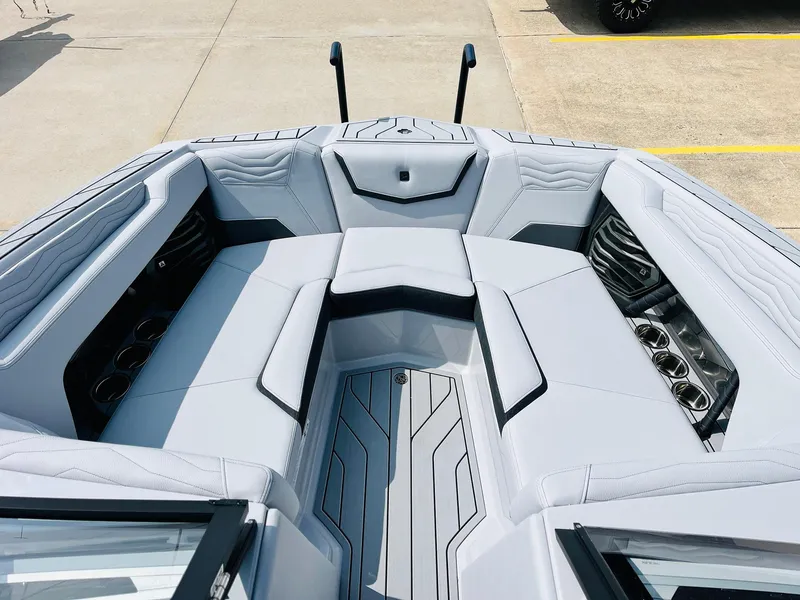 Slide: The Image of 2025 Nautique Super Air G23 boat interior with sleek seating and cup holders. - 14