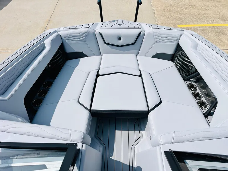 Slide: The Image of 2025 Nautique Super Air G23 boat interior with luxurious seating and cup holders. - 17