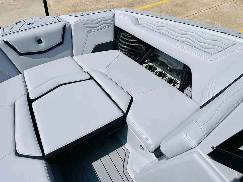 Slide: The Image of 2025 Nautique Super Air G23 boat interior with sleek gray seating and cup holders. - 19