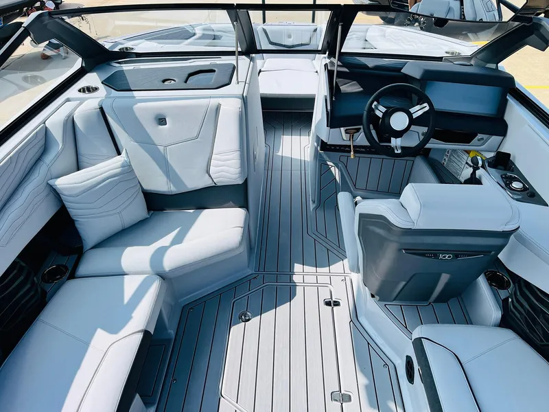 Slide: The Image of 2025 Nautique Super Air G23 boat interior with sleek seating and modern dashboard design. - 24