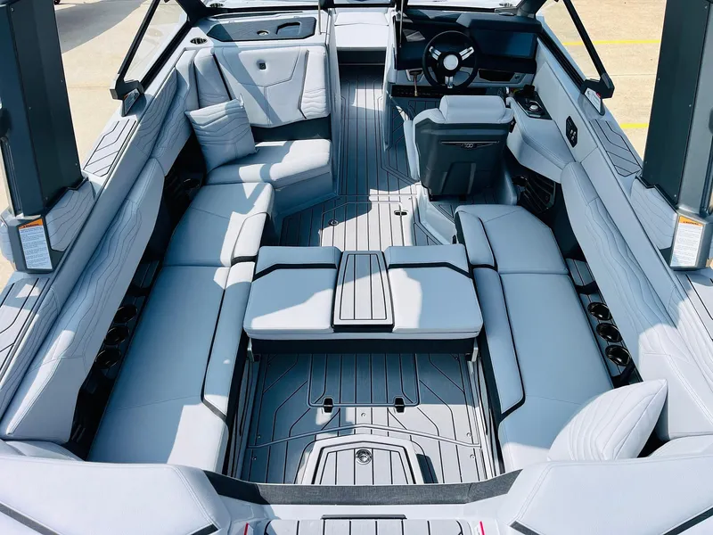 Slide: The Image of 2025 Nautique Super Air G23 interior with luxurious seating and modern dashboard design. - 38