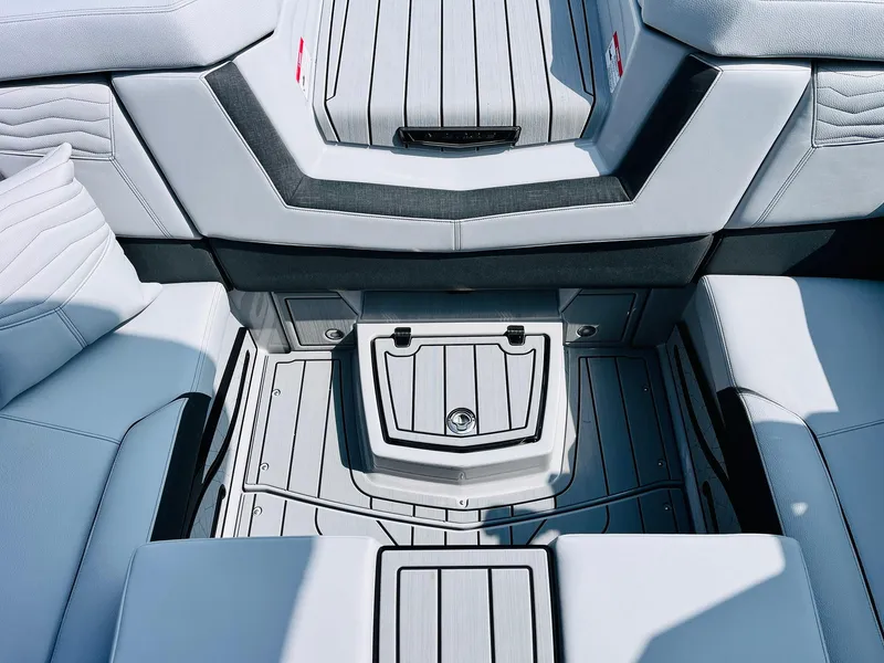 Slide: The Image of 2025 Nautique Super Air G23 boat interior with sleek, modern seating and storage design. - 39