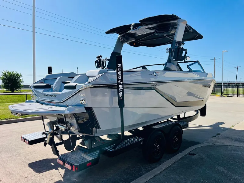 Slide: The Image of 2025 Nautique Super Air G23 boat on trailer, sleek design, sunny day. - 4