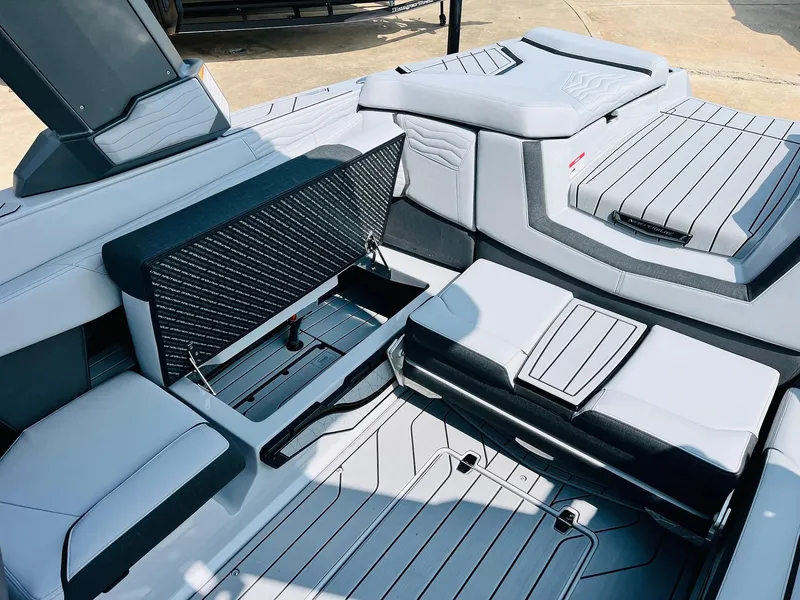 Slide: The Image of 2025 Nautique Super Air G23 boat interior with sleek seating and storage compartments. - 42