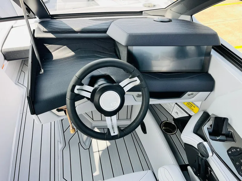 Slide: The Image of 2025 Nautique Super Air G23 boat cockpit with modern steering and dashboard design. - 46