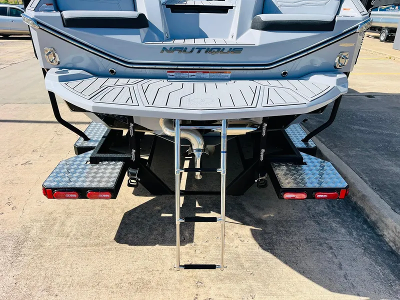 Slide: The Image of 2025 Nautique Super Air G23 boat rear view with swim platform and ladder. - 7