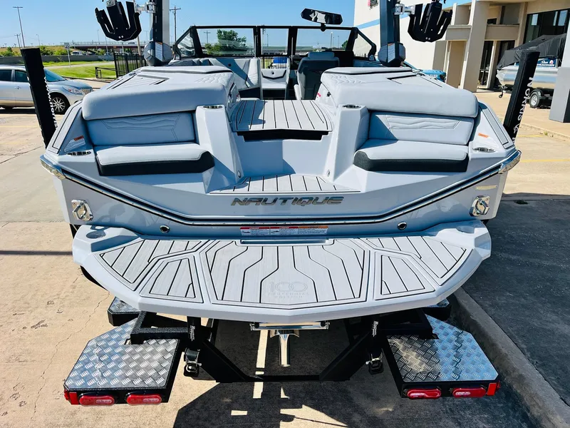 Slide: The Image of 2025 Nautique Super Air G23 boat rear view with sleek design and spacious seating. - 9