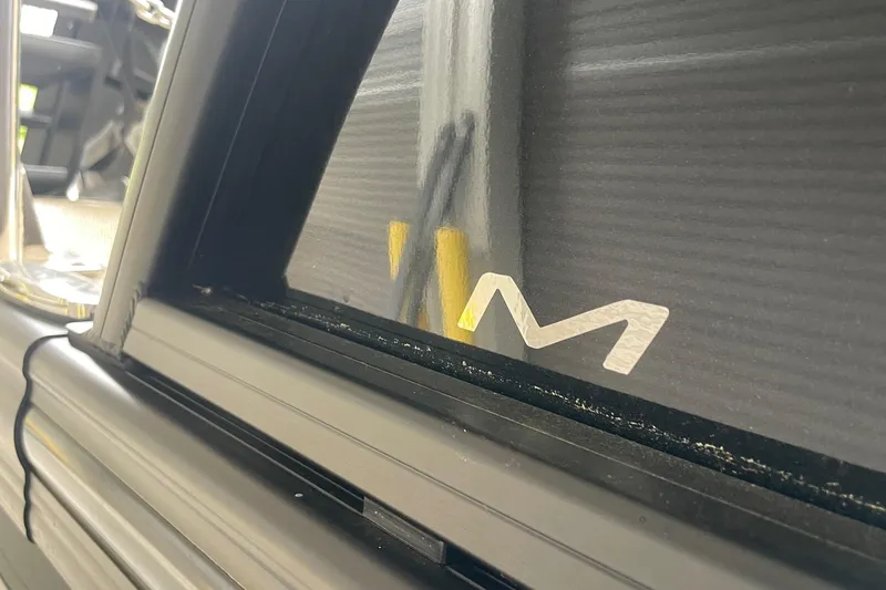 Slide: The Image of 2025 Barletta L25MAT boat window detail with logo. - 14