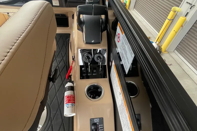 Slide: The Image of Control panel of 2025 Barletta L25MAT boat with cup holder and safety equipment. - 5