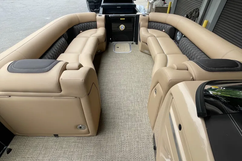 Slide: The Image of 2025 Barletta L25MAT pontoon boat interior with beige seating and carpet flooring. - 7