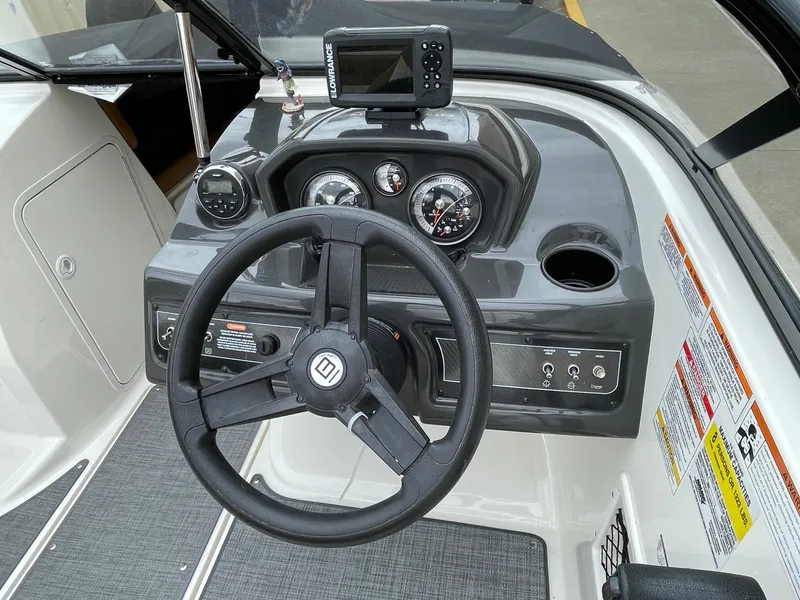 Slide: The Image of 2019 Bayliner VR5 Bowrider I/O dashboard with steering wheel and gauges. - 2