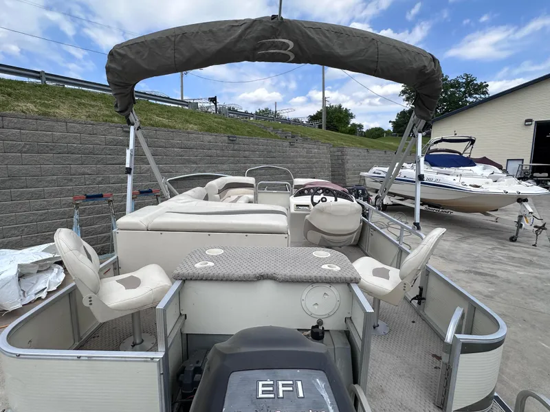 Slide: The Image of 2007 Bennington 2075GSi pontoon boat with canopy, docked outdoors under a cloudy sky. - 10