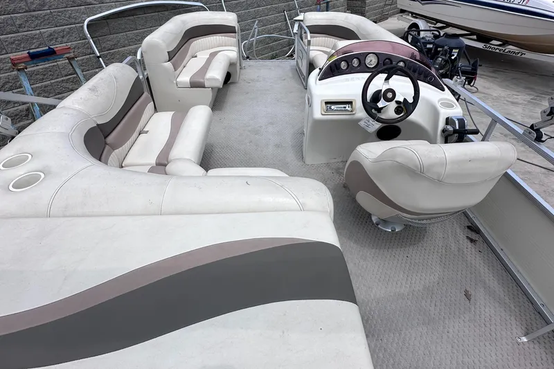 Slide: The Image of 2007 Bennington 2075GSi pontoon boat interior with plush seating and steering console. - 11