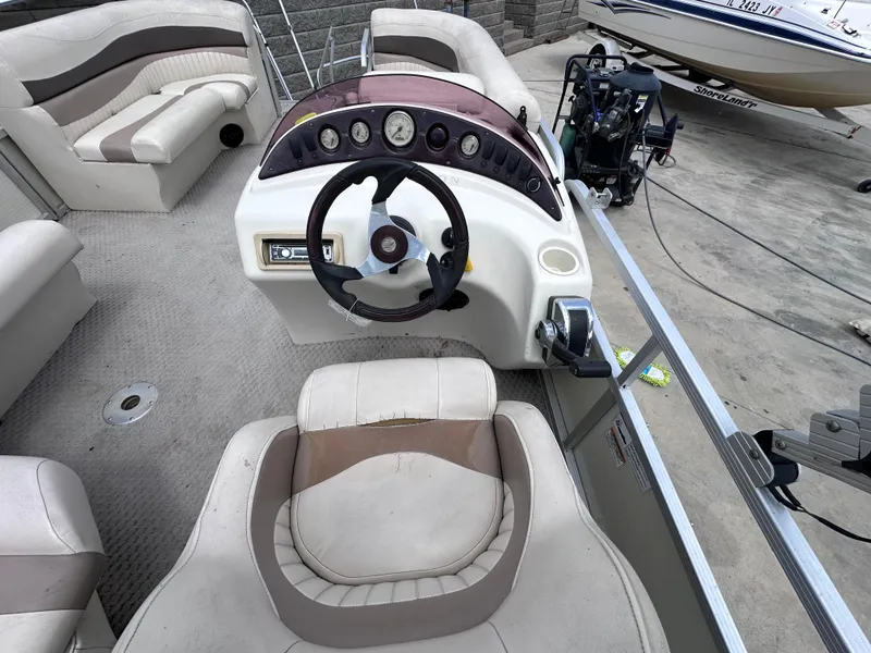 Slide: The Image of 2007 Bennington 2075GSi boat interior with steering wheel and seating arrangement. - 4