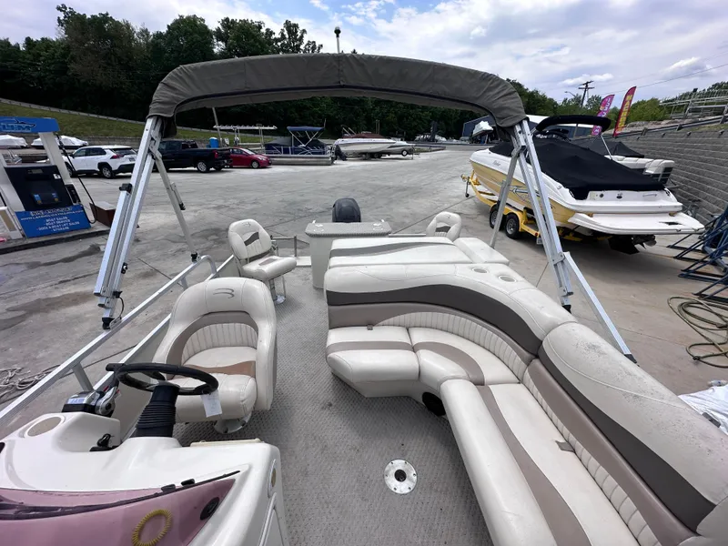 Slide: The Image of 2007 Bennington 2075GSi pontoon boat with canopy, parked in a marina lot. - 6