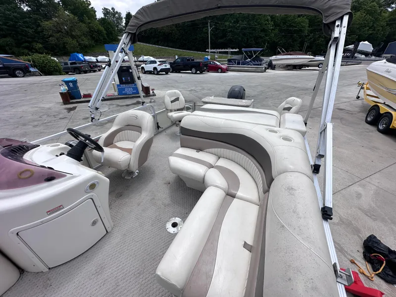 Slide: The Image of 2007 Bennington 2075GSi pontoon boat with spacious seating and canopy, parked at a marina. - 8