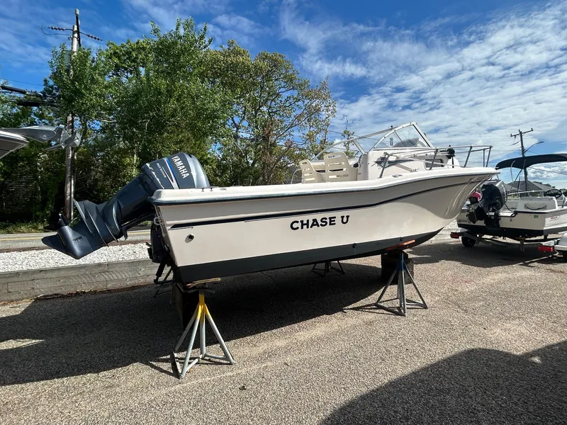 Slide: The Image of 2006 Grady-White Adventure 208 boat on stands, outdoors under a partly cloudy sky. - 1