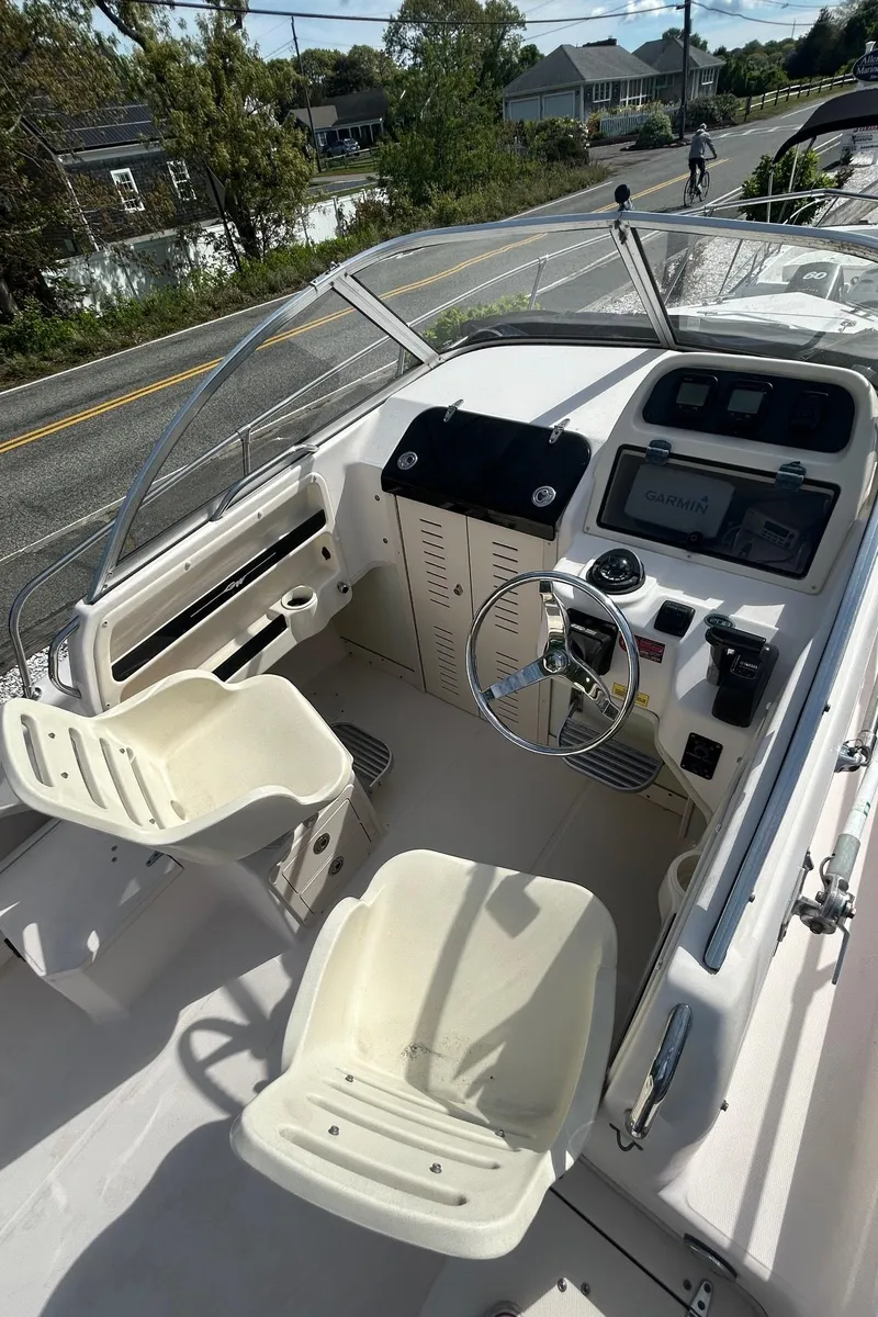 Slide: The Image of 2006 Grady-White Adventure 208 boat cockpit with steering wheel and seating. - 11