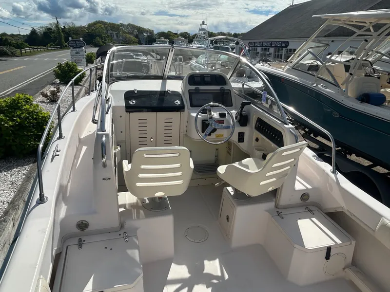 Slide: The Image of 2006 Grady-White Adventure 208 boat interior with steering wheel and seating. - 4