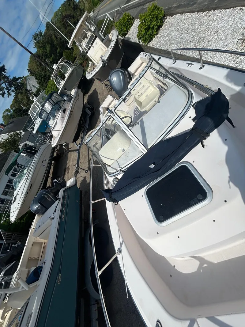 Slide: The Image of 2006 Grady-White Adventure 208 boat docked among other vessels. - 5