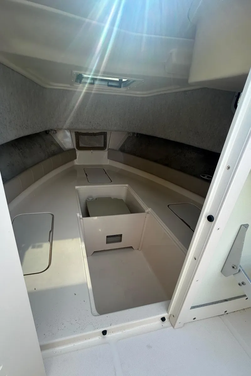 Slide: The Image of 2006 Grady-White Adventure 208 boat interior with sunlight streaming through hatch. - 9